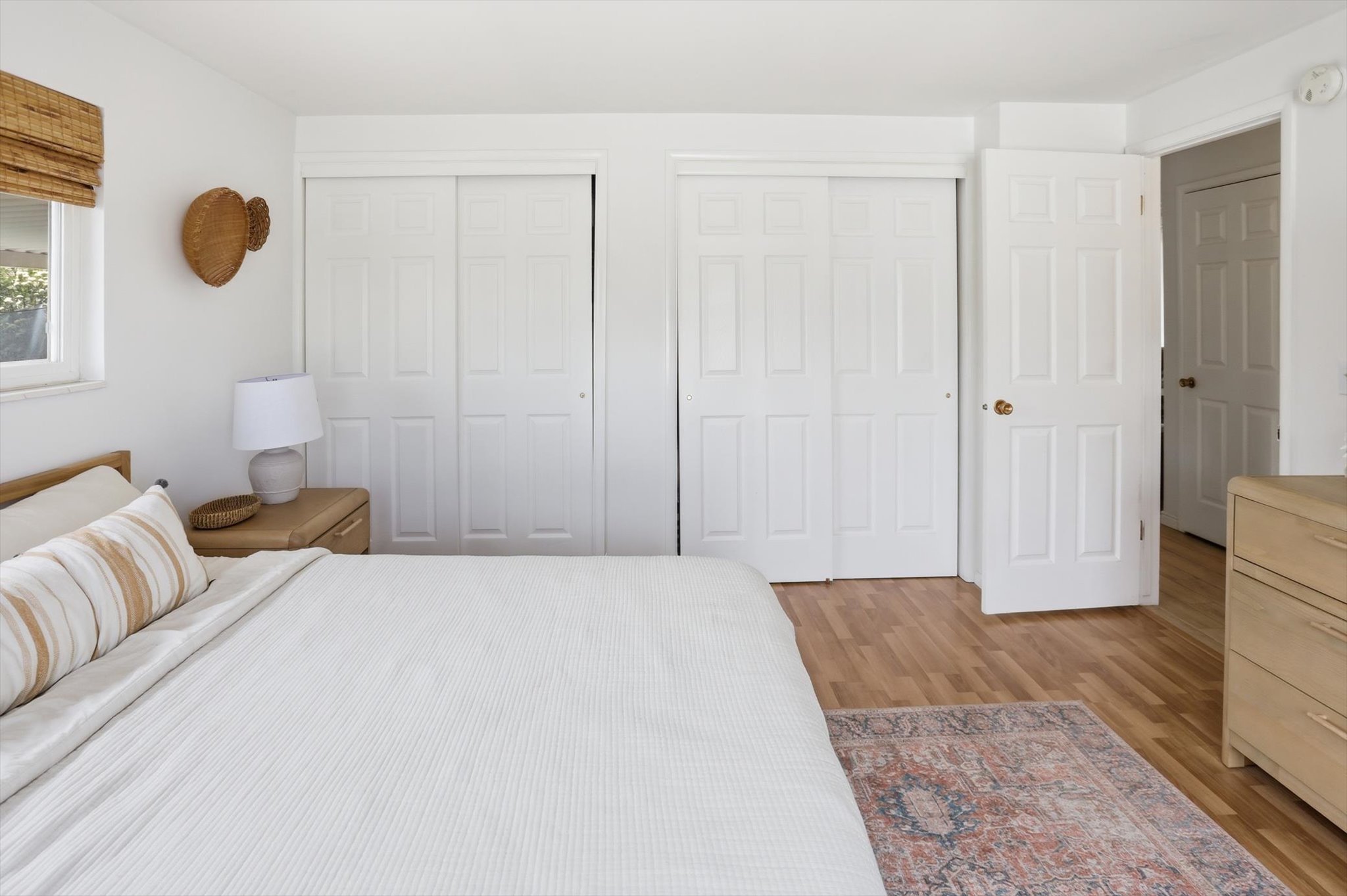Bedroom featuring two closets and light wood finished floors