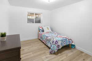 Bedroom featuring light wood-style floors and baseboards