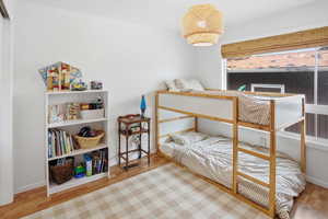 Bedroom featuring light wood-style flooring and baseboards