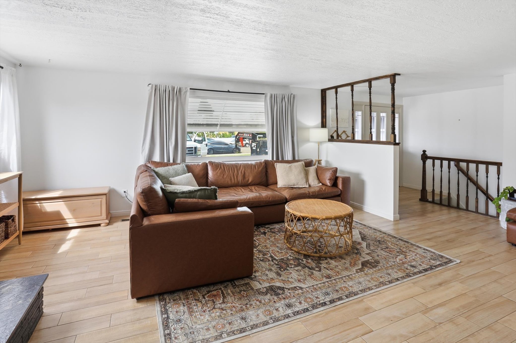 Living room featuring light wood-style floors and a textured ceiling