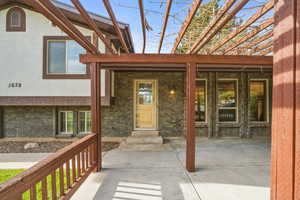 Inviting front entry with covered porch and pergola, providing shade and character as you welcome guests inside.