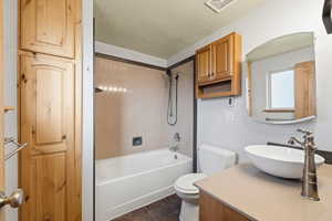 Full bathroom with tub/shower combination, updated fixtures, and built-in storage.