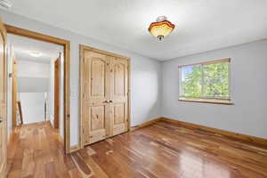 Comfortable bedroom with hardwood floors, closet space, and easy access to nearby living areas.