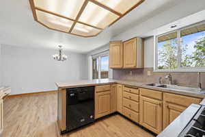 Open kitchen layout with breakfast bar seating, abundant cabinetry, and seamless flow into the dining area with backyard access.