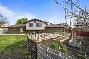 Dedicated garden space with raised beds and fencing, ideal for planting and growing.