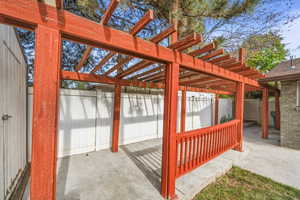 Private backyard patio with pergola structure, creating a charming outdoor living space.