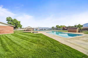 Community pool area with surrounding seating and open space for relaxation and recreation.
