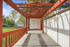 Covered outdoor walkway with pergola detail, offering a shaded space for relaxing or entertaining.