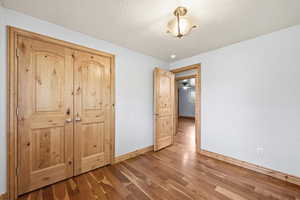 Comfortable bedroom with warm wood finishes, ample closet space, and easy access to the main living areas.