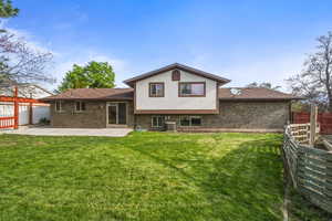 Spacious backyard with open lawn area and patio, offering plenty of room for outdoor activities.