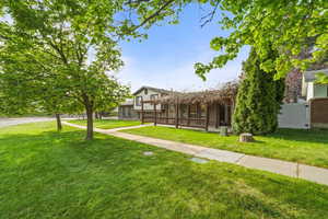 Covered front porch with pergola detail creates a cozy outdoor space perfect for relaxing or entertaining.