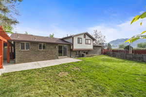 Large backyard with patio access and mountain views, creating a great space for outdoor enjoyment.