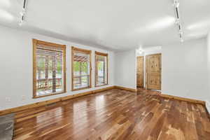 Spacious living area with abundant natural light, custom wood trim, and a comfortable, open layout.