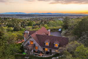 Aerial view of property and surrounding area featuring mountains