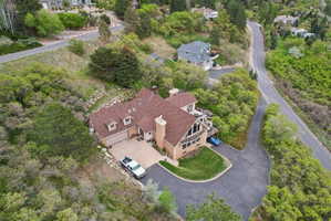 View from above of property with a tree filled landscape