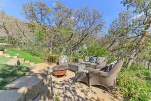 View of patio with an outdoor fire pit