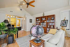Living room featuring light tile patterned floors and a ceiling fan