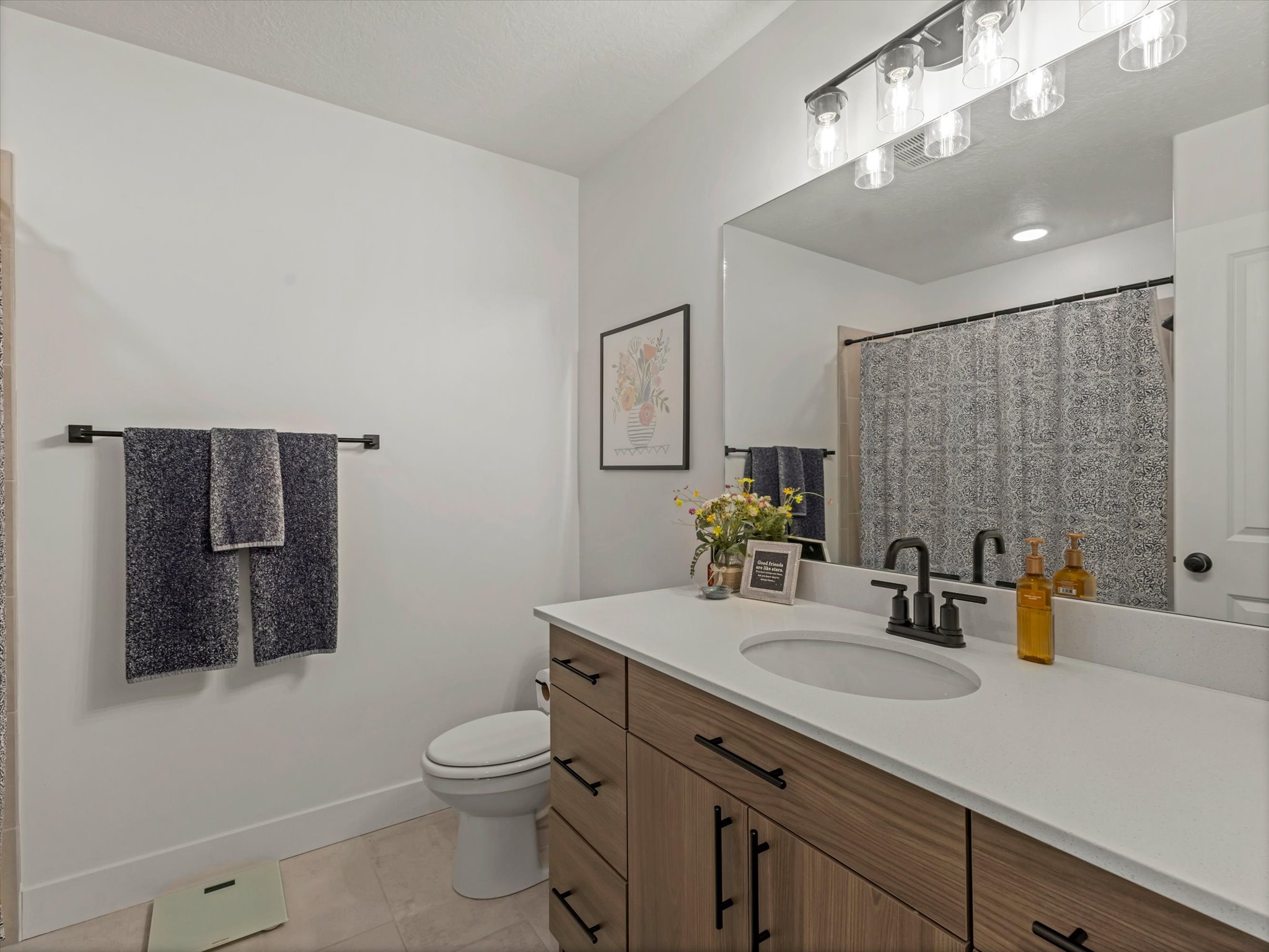 Bathroom with vanity, a shower with shower curtain, and light tile patterned floors