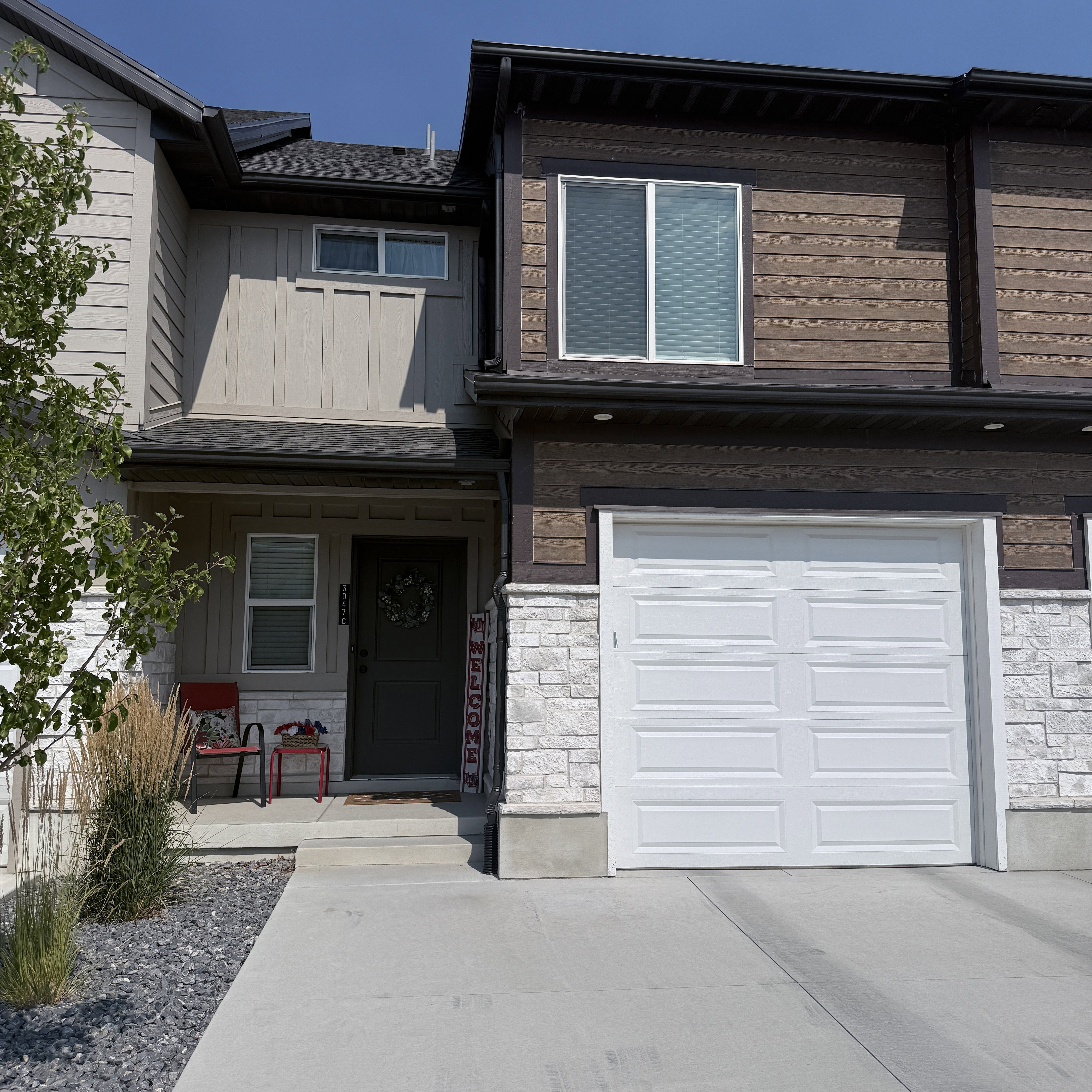 Modern façade featuring horizontal siding and stone accents