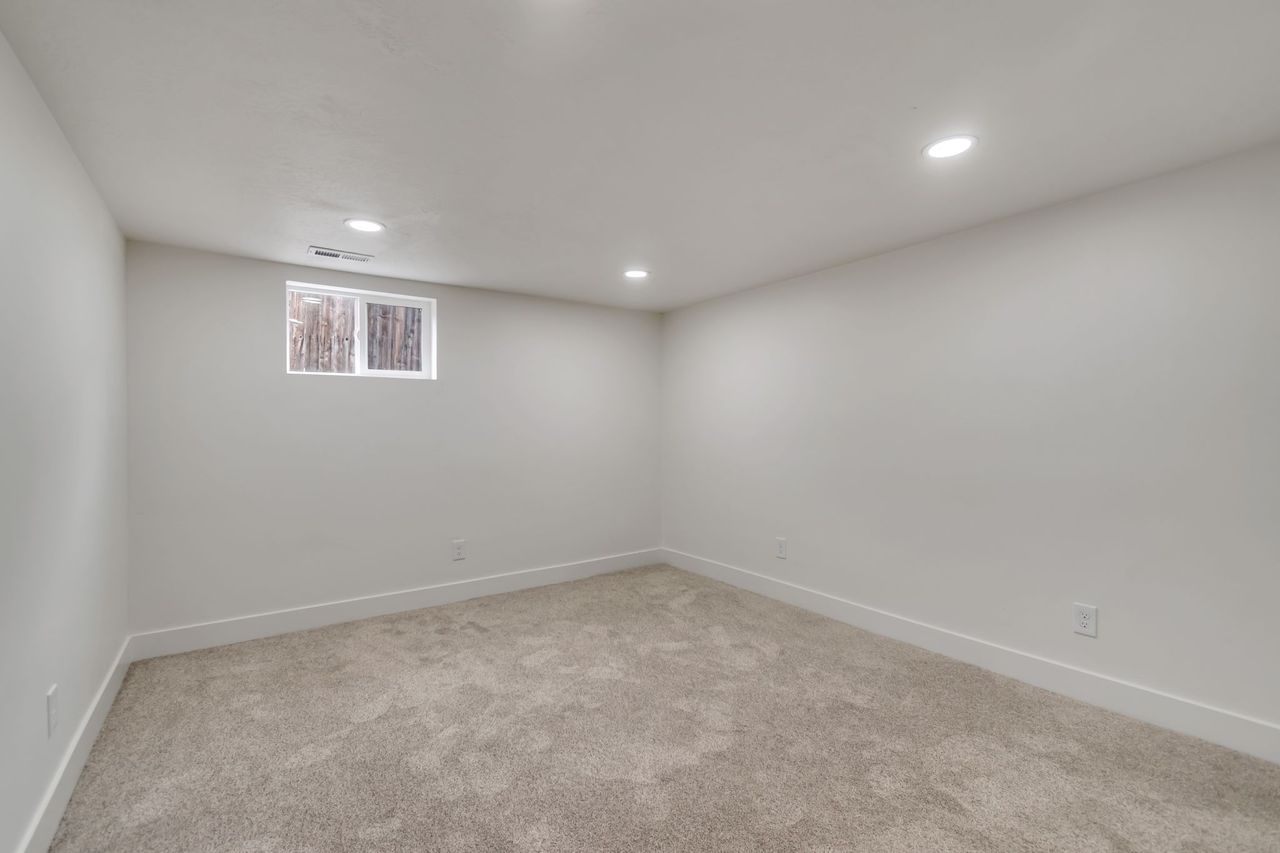 Below grade area with carpet flooring and recessed lighting