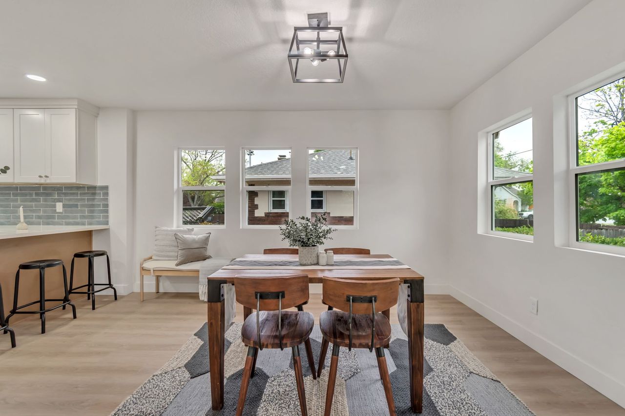 Dining area with light wood finished floors and recessed lighting
