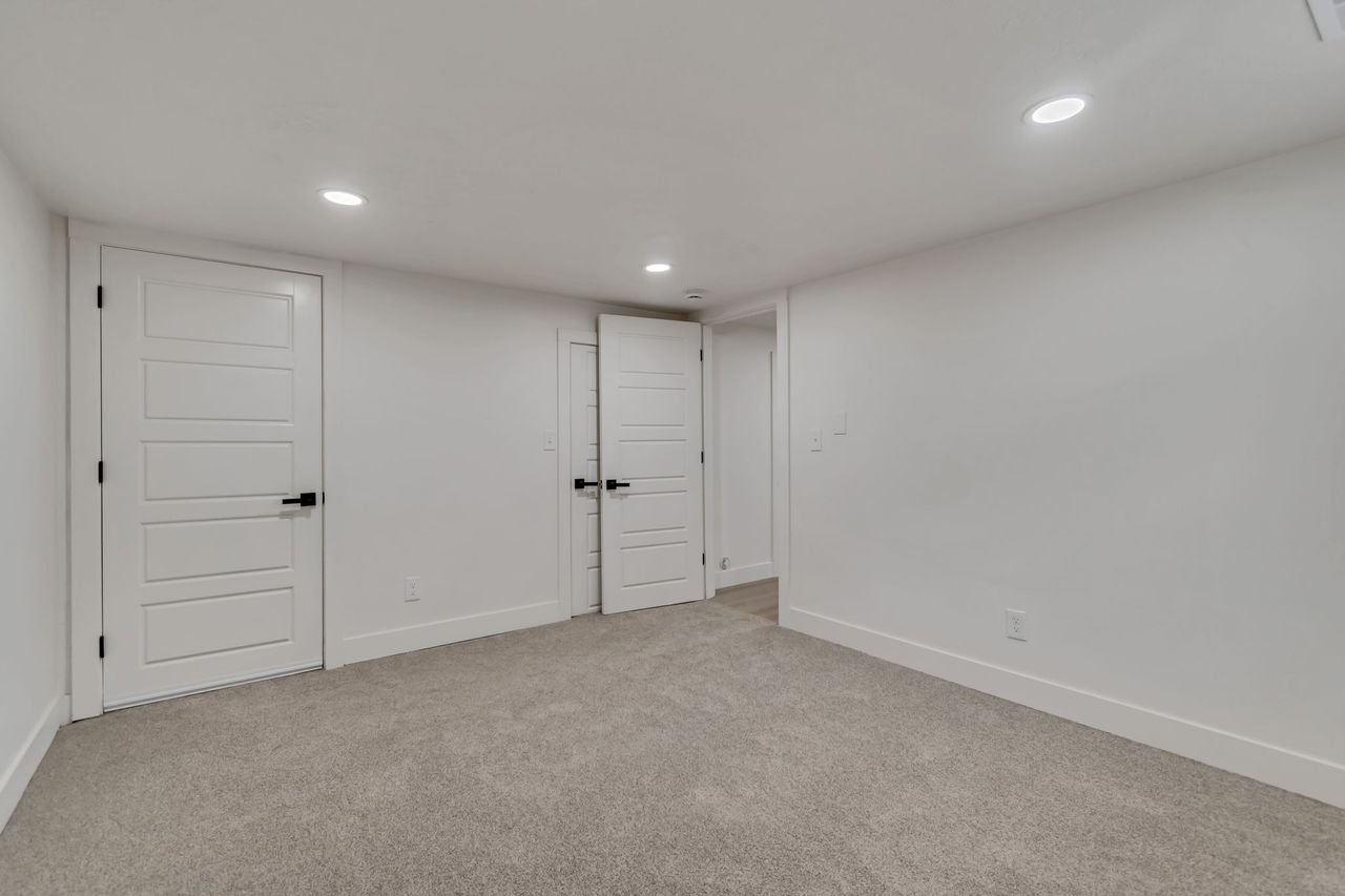 Finished below grade area featuring recessed lighting and light colored carpet