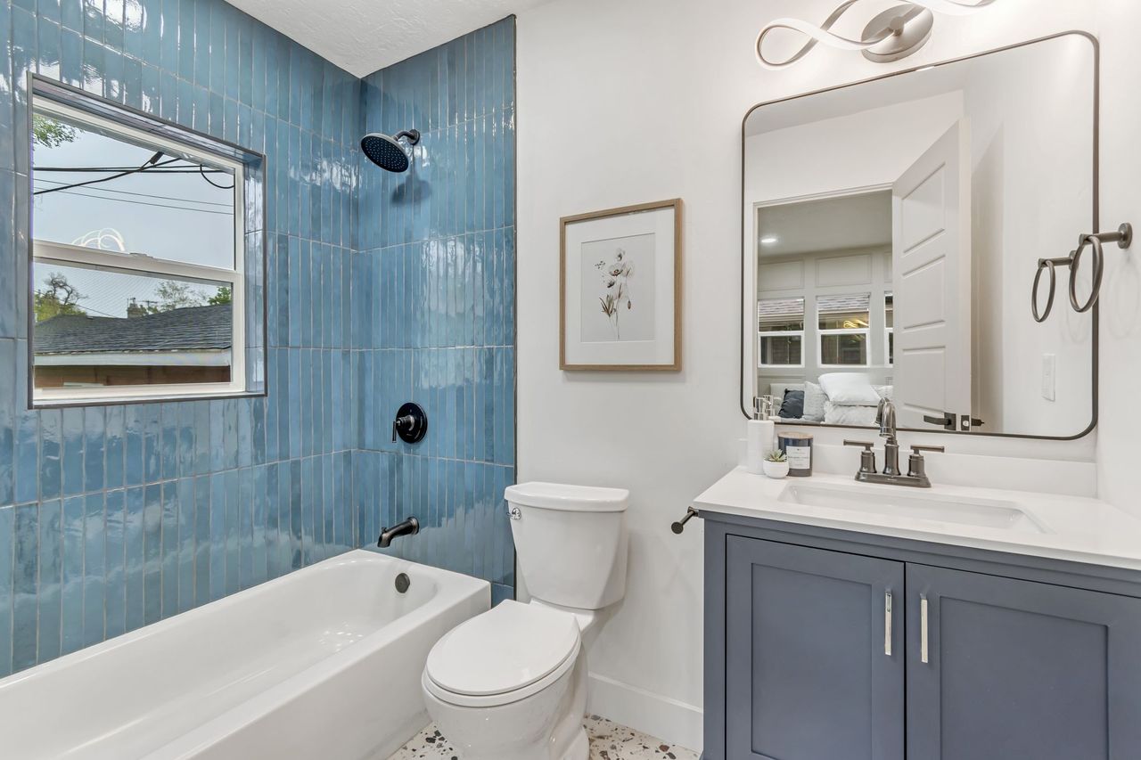 Full bath with vanity, shower / bath combination, and connected bathroom