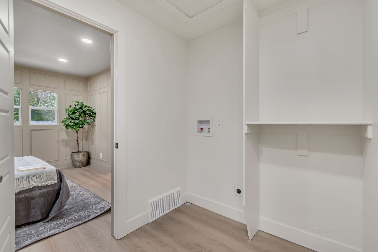 Laundry room with light wood finished floors, recessed lighting, hookup for a washing machine, and a decorative wall