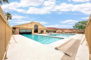 Community pool featuring a patio