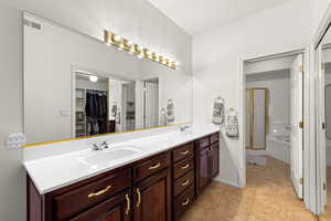 Bathroom featuring double vanity and a bath