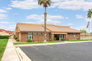 View of property featuring uncovered parking