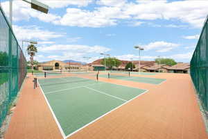 View of tennis court featuring a residential view