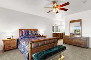 Bedroom featuring light carpet, ceiling fan, and a textured ceiling
