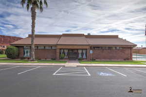View of building exterior with uncovered parking