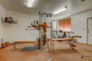 Exercise area featuring a textured ceiling