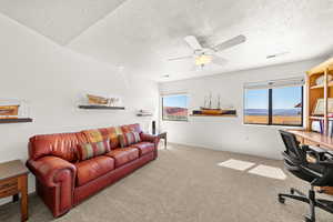 Office with light carpet, a textured ceiling, and a ceiling fan