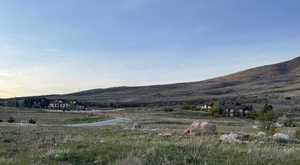 View of mountain backdrop featuring rural landscape