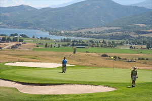 View of home's community featuring view of golf course and a water and mountain view