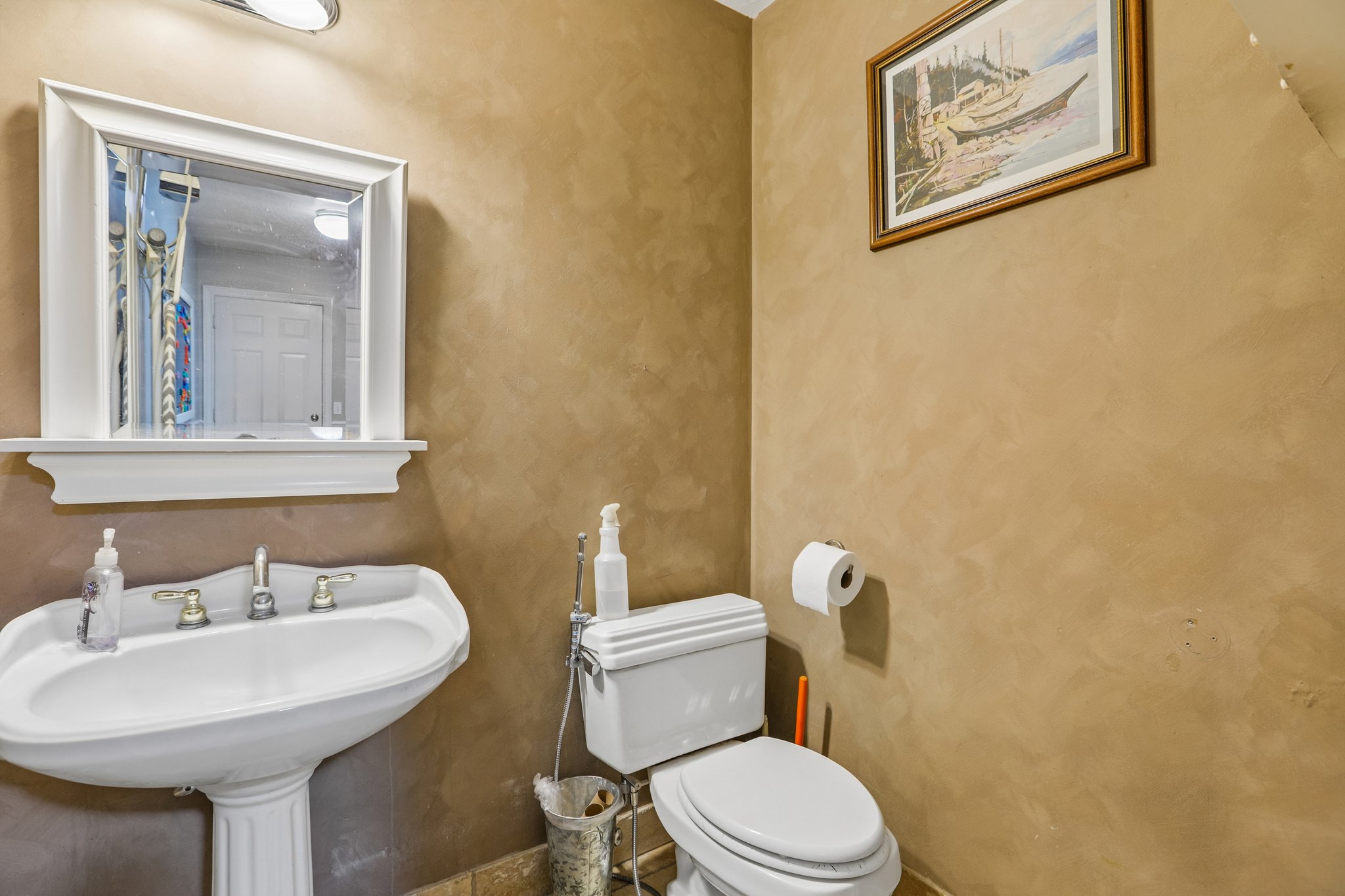 Half bath featuring toilet and a sink