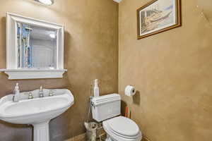 Half bath featuring toilet and a sink