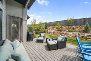 Deck featuring an outdoor lounge area, area for grilling, and a fenced backyard