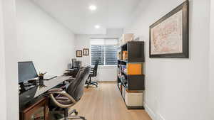 Office featuring light wood finished floors and recessed lighting