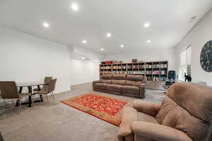 Living room with light colored carpet and recessed lighting