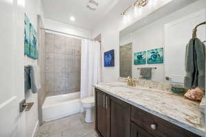 Bathroom featuring vanity and shower / bath combo