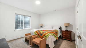 Carpeted bedroom with baseboards