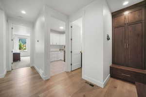 Corridor featuring recessed lighting and light wood-style flooring