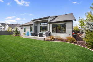 Rear view of property featuring a wooden deck, a shingled roof, and an outdoor lounge area