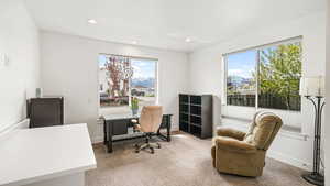 Office area featuring a mountain view, light colored carpet, and recessed lighting