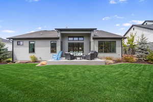 Rear view of property featuring outdoor lounge area, roof with shingles, and a deck