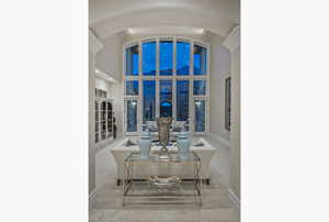 Dining space featuring a high ceiling and baseboards